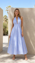 Front view of model wearing light blue textured halter neck maxi dress