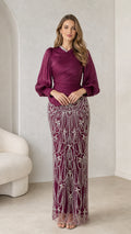 Front view of burgundy long sleeve embellished evening dress