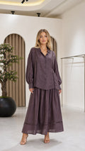 Front view of a mauve women's blouse and flowing maxi skirt two-piece set