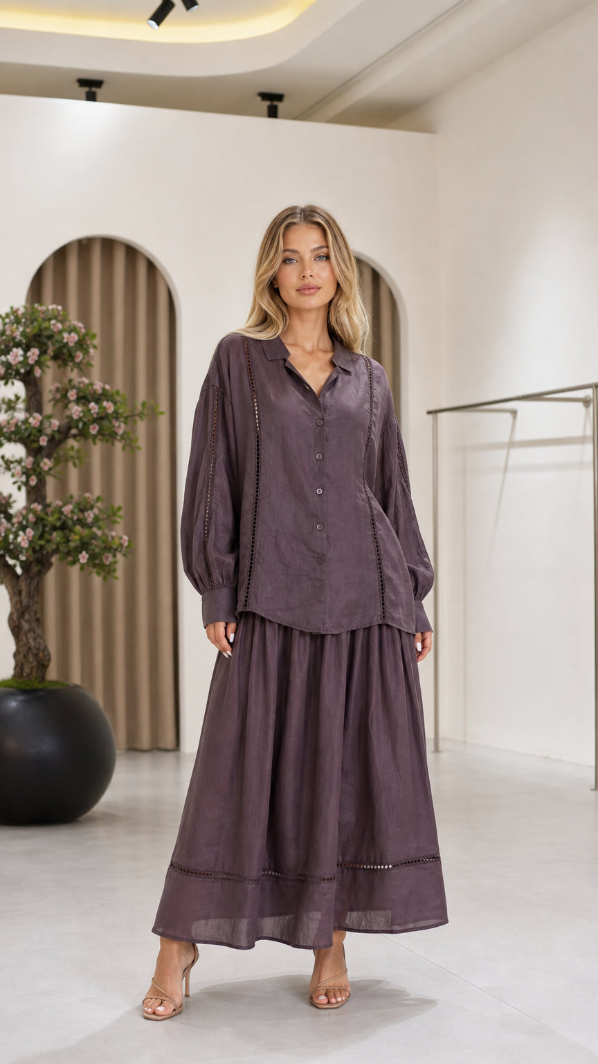 Front view of a mauve women's blouse and flowing maxi skirt two-piece set