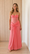 Front view of model wearing coral strapless corset maxi dress