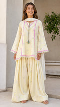 Front view of woman wearing yellow striped ethnic kurti and sharara set