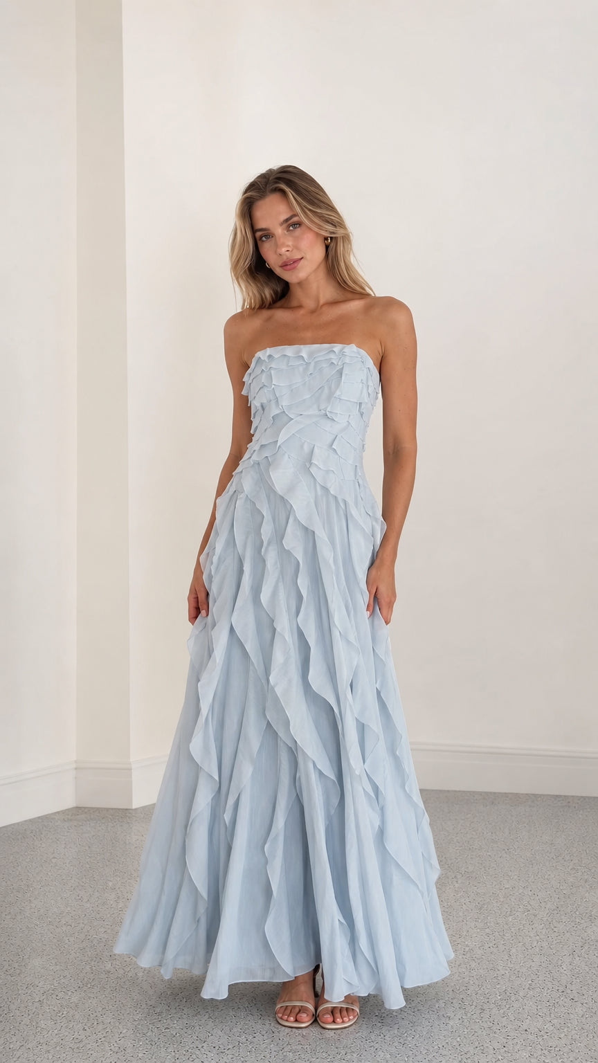 Front view of model wearing light blue strapless ruffle maxi dress