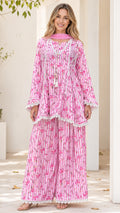 Front view of model wearing pink floral striped tunic and pants set with dupatta