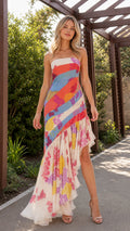 Front view of model wearing white multi strapless floral ruffle high-low maxi dress