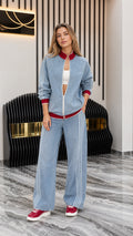 Front view of model wearing Light Blue denim track jacket and wide-leg pants set