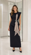 Front view of woman wearing black formal maxi dress with pearl sash