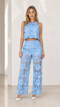 Front view of model wearing blue floral lace crop top and wide leg pants set