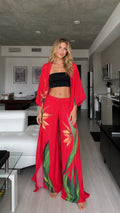 Model wearing red floral kimono cardigan and wide leg pants set from the front