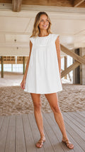 Woman wearing white sleeveless eyelet trim mini dress front view