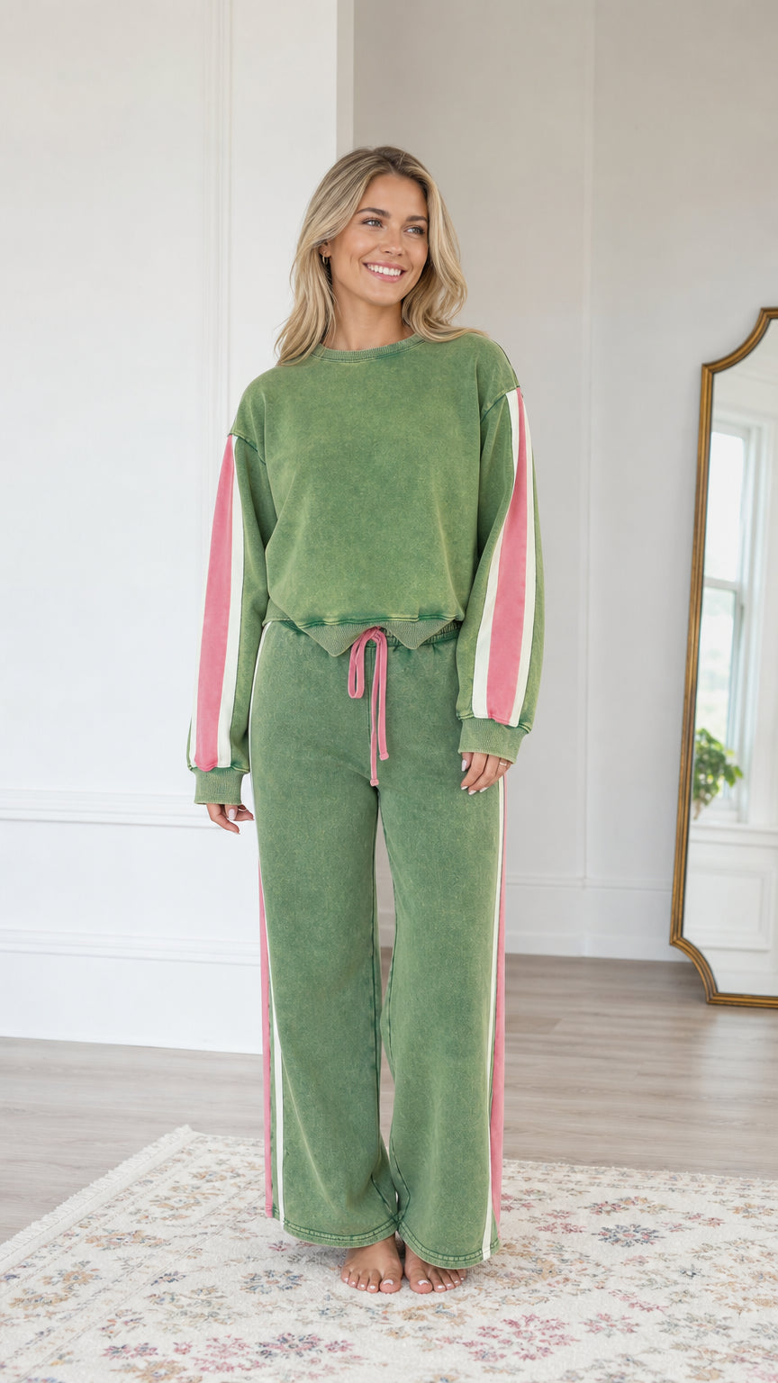 Front view of model wearing the Sage Green vintage washed sweatshirt and wide-leg sweatpants set with pink side stripes