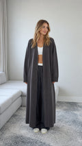 Front view of model wearing a Charcoal Grey floor length maxi duster cardigan