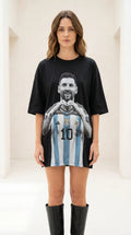 Front view of black graphic t-shirt dress with knee-high boots