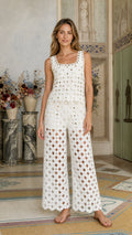 Front view of model wearing white crochet tank top and wide-leg pants set