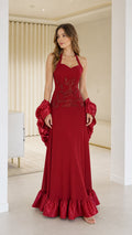 Front view of woman wearing red halter neck evening dress with shawl