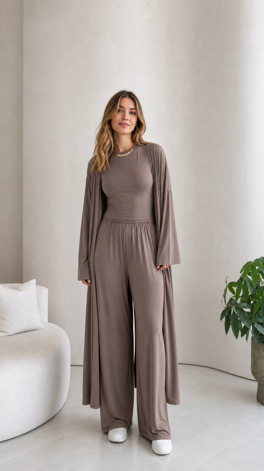 Front view of model wearing the taupe 3-piece lounge set with long duster cardigan, top, and wide-leg pants