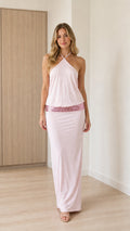 Front view of model wearing pink halter maxi dress with sequin waist