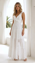 Front view of woman wearing white ruffle eyelet tiered maxi dress with lace-up sides