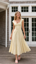 Front view of yellow floral midi dress on model