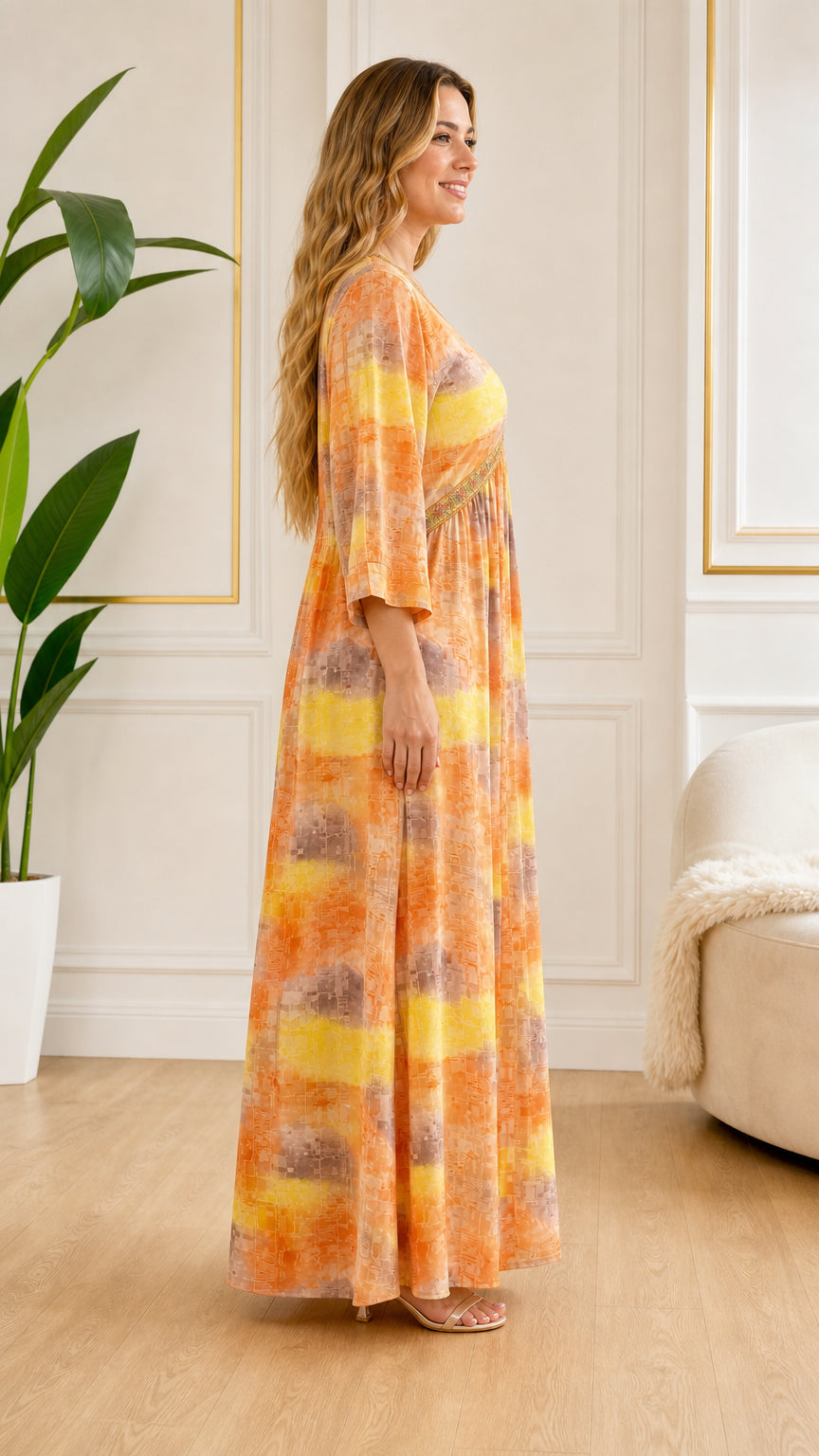 Side profile view of model wearing flowy Orange printed maxi dress