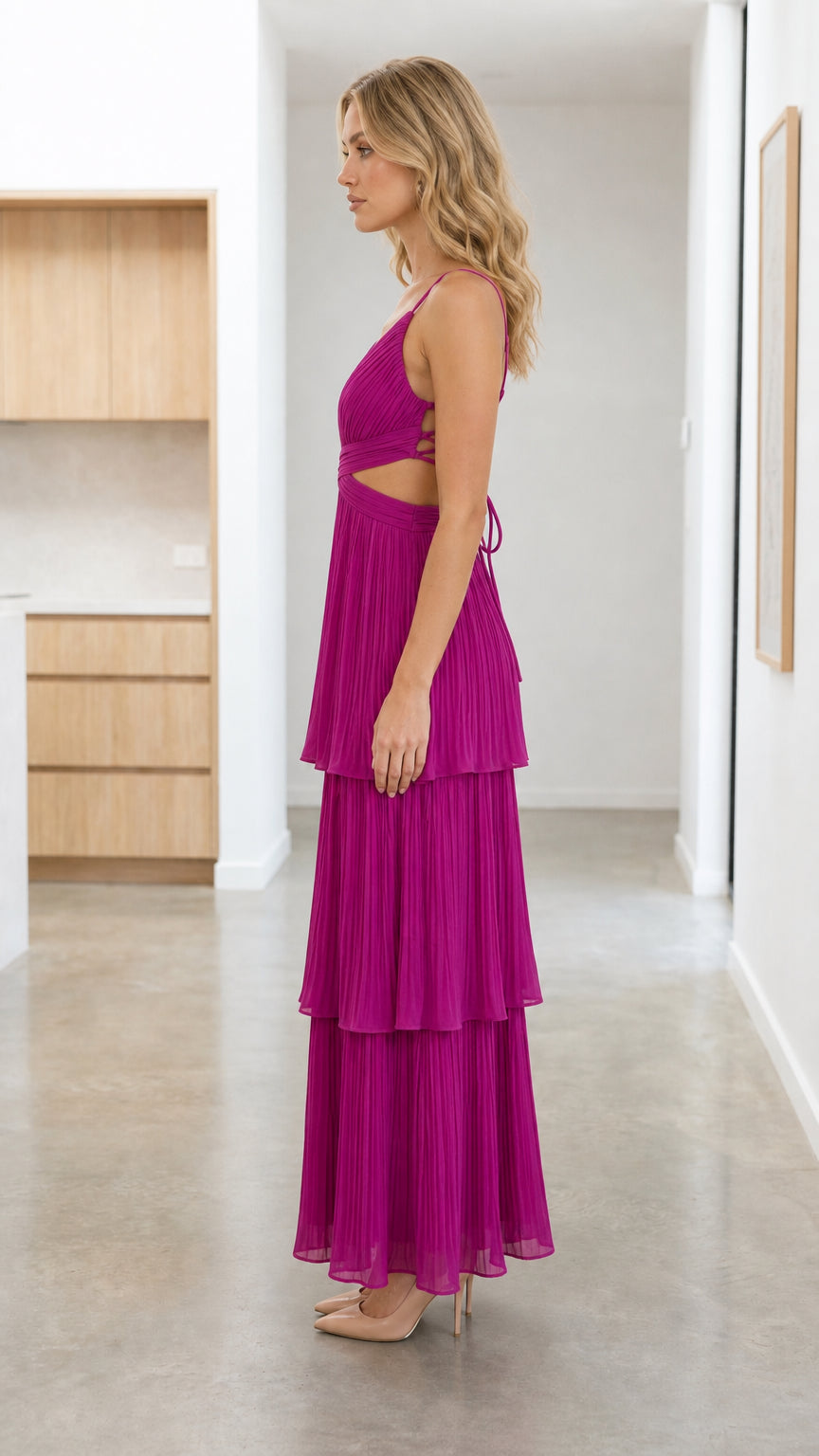Side profile view of Fuchsia pleated maxi dress