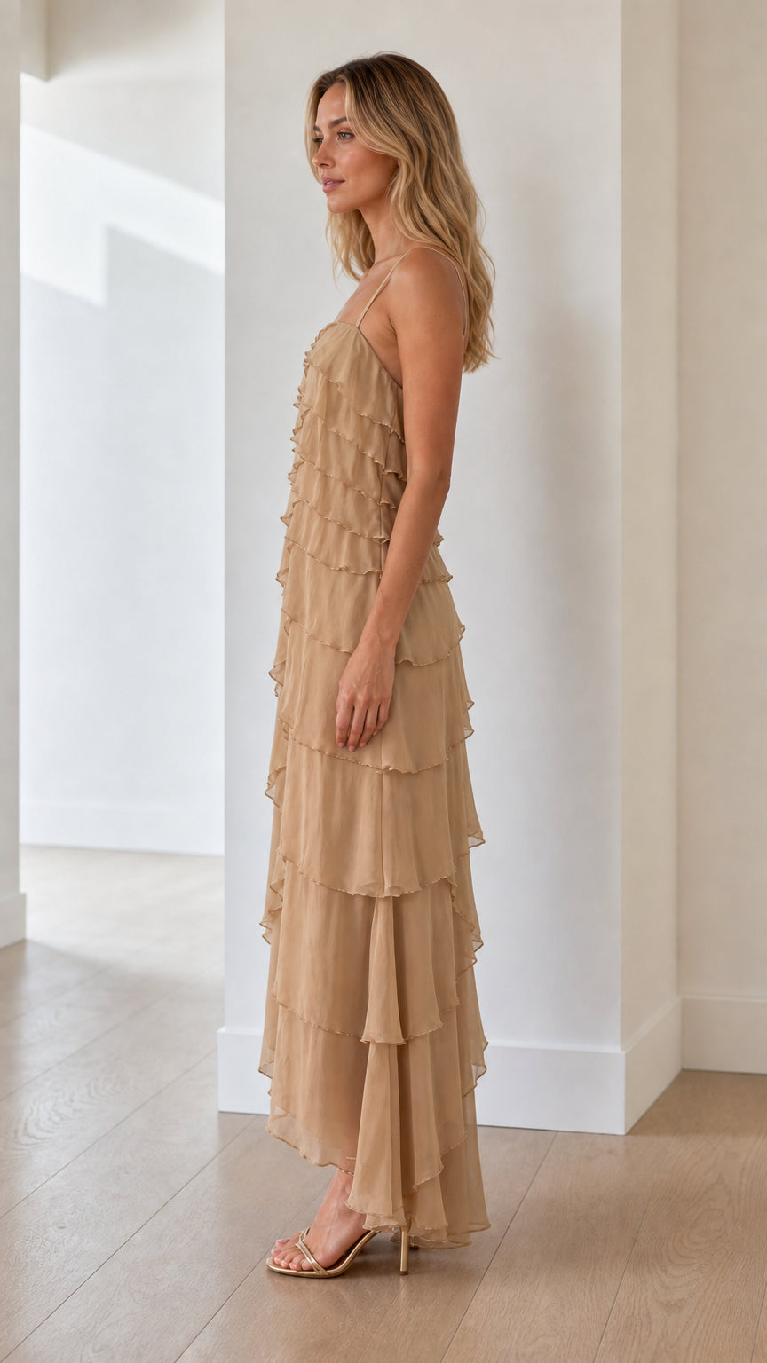 Model wearing beige tiered ruffle maxi dress from the side