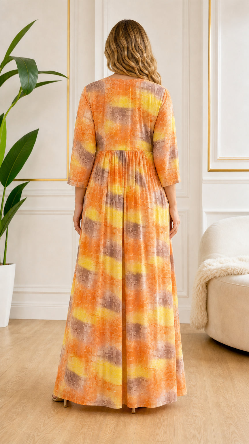 Back view of model showing full length drape of Orange abstract print maxi dress