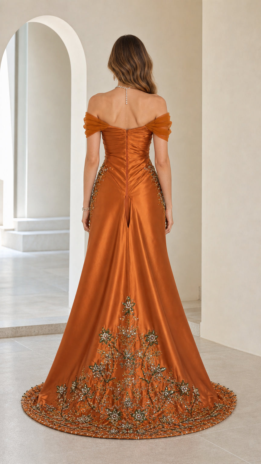 Back view showcasing detailed embroidery on the train of rust orange gown