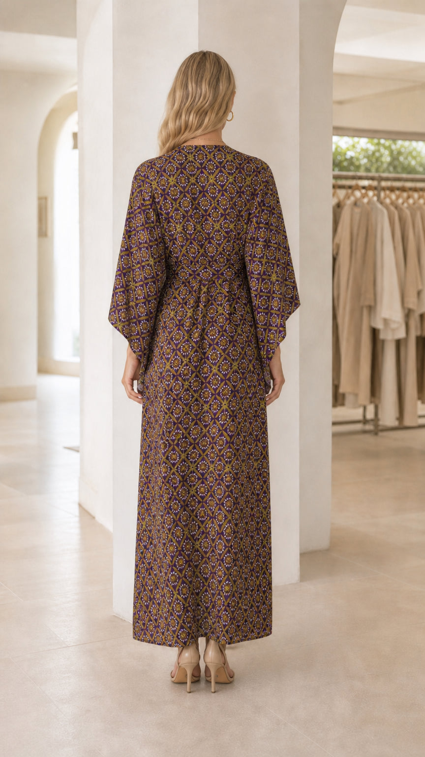 Model wearing purple printed maxi dress from the back