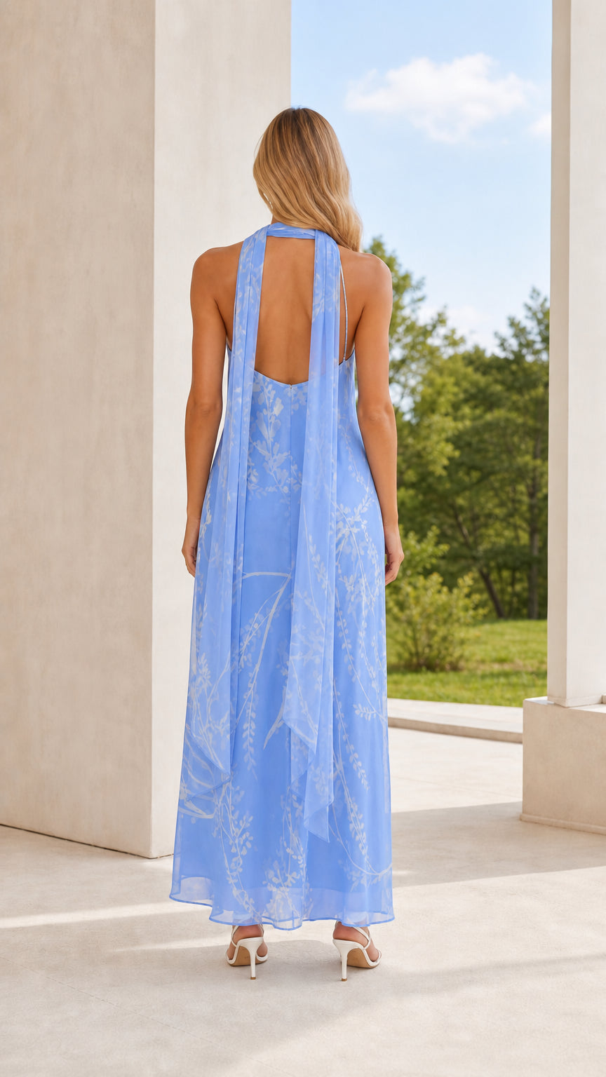 Back view of model showing halter neck scarf tie on blue maxi dress