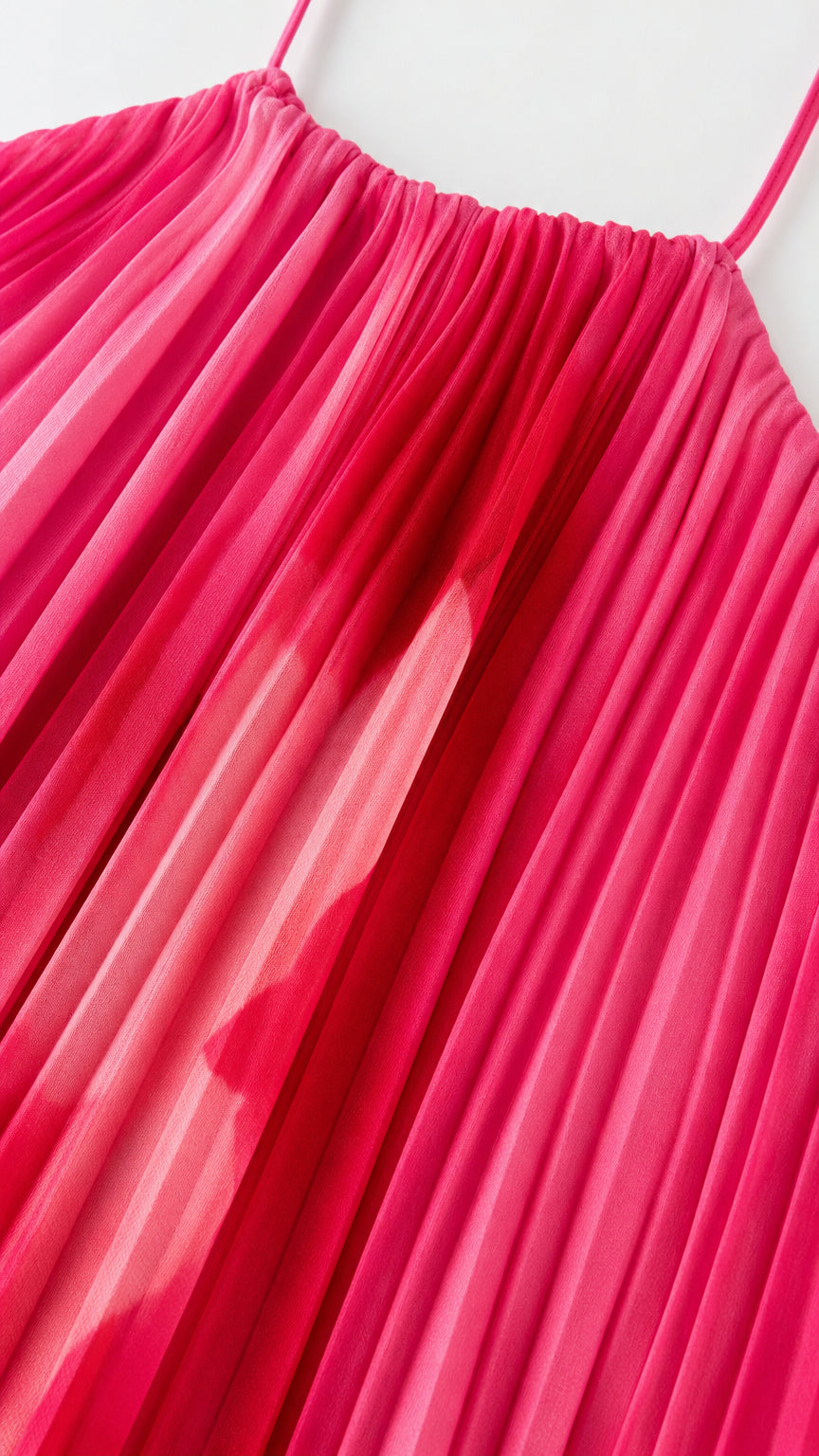 Close-up detail of accordion pleats and halter neckline