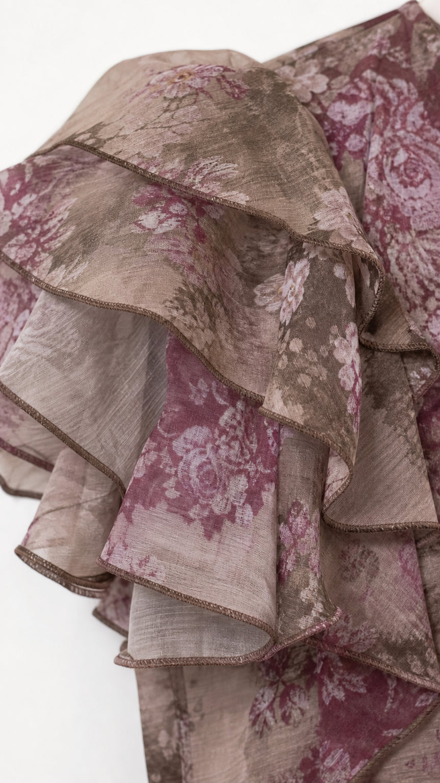 Close-up of taupe floral fabric and layered ruffle detailing