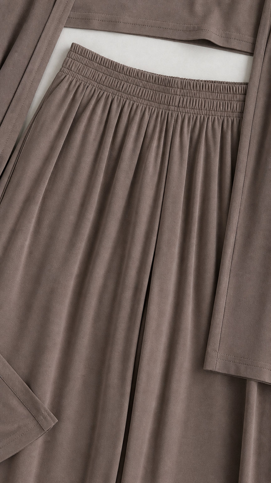 Close-up detail of the gathered elastic waistband, soft fabric texture, and sleeve cuff