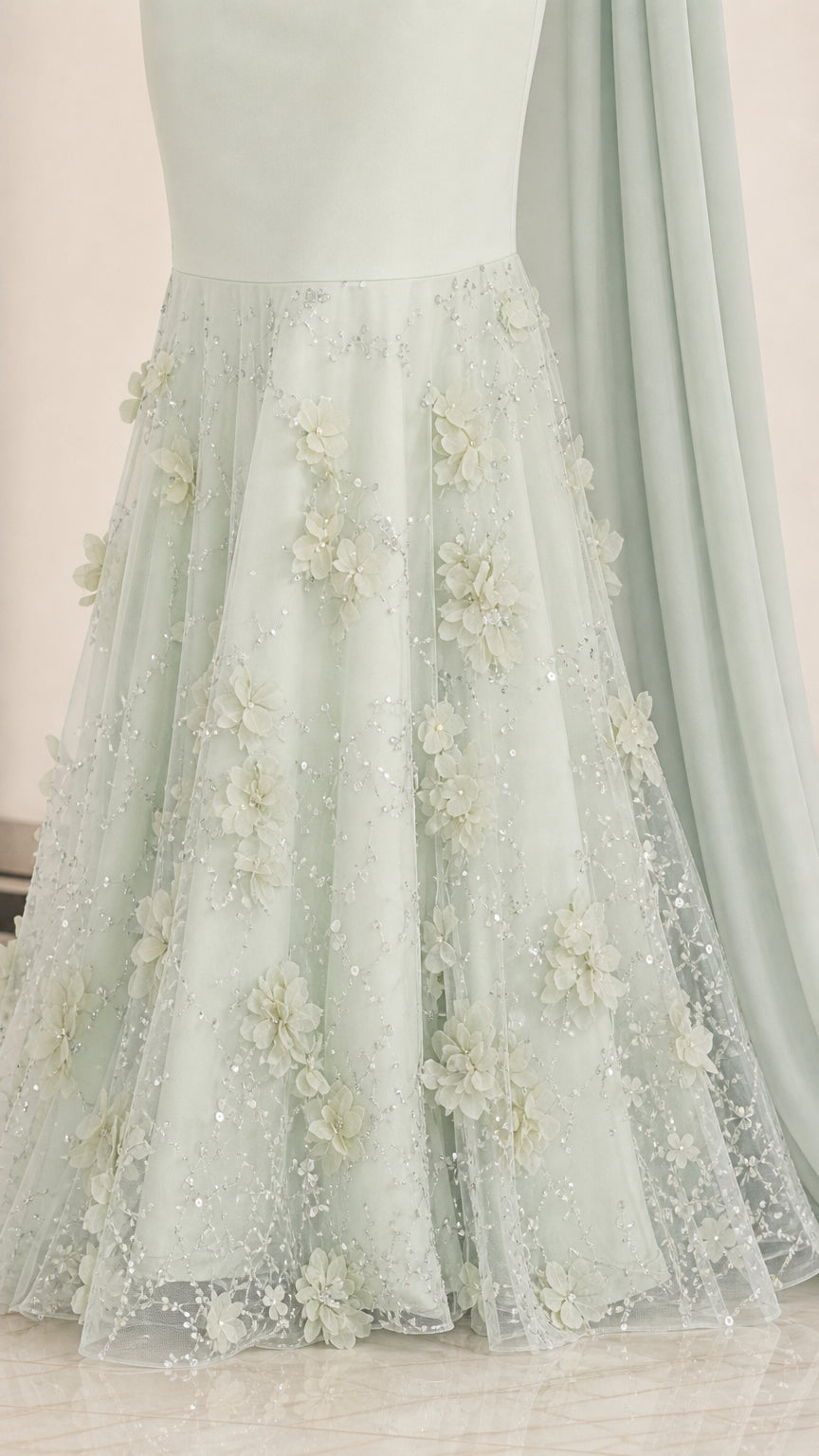 Close-up detail of 3D floral lace and sparkle on the dress hem