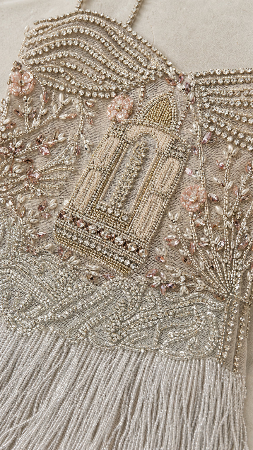 Close-up detail of intricate bodice beadwork and fringe