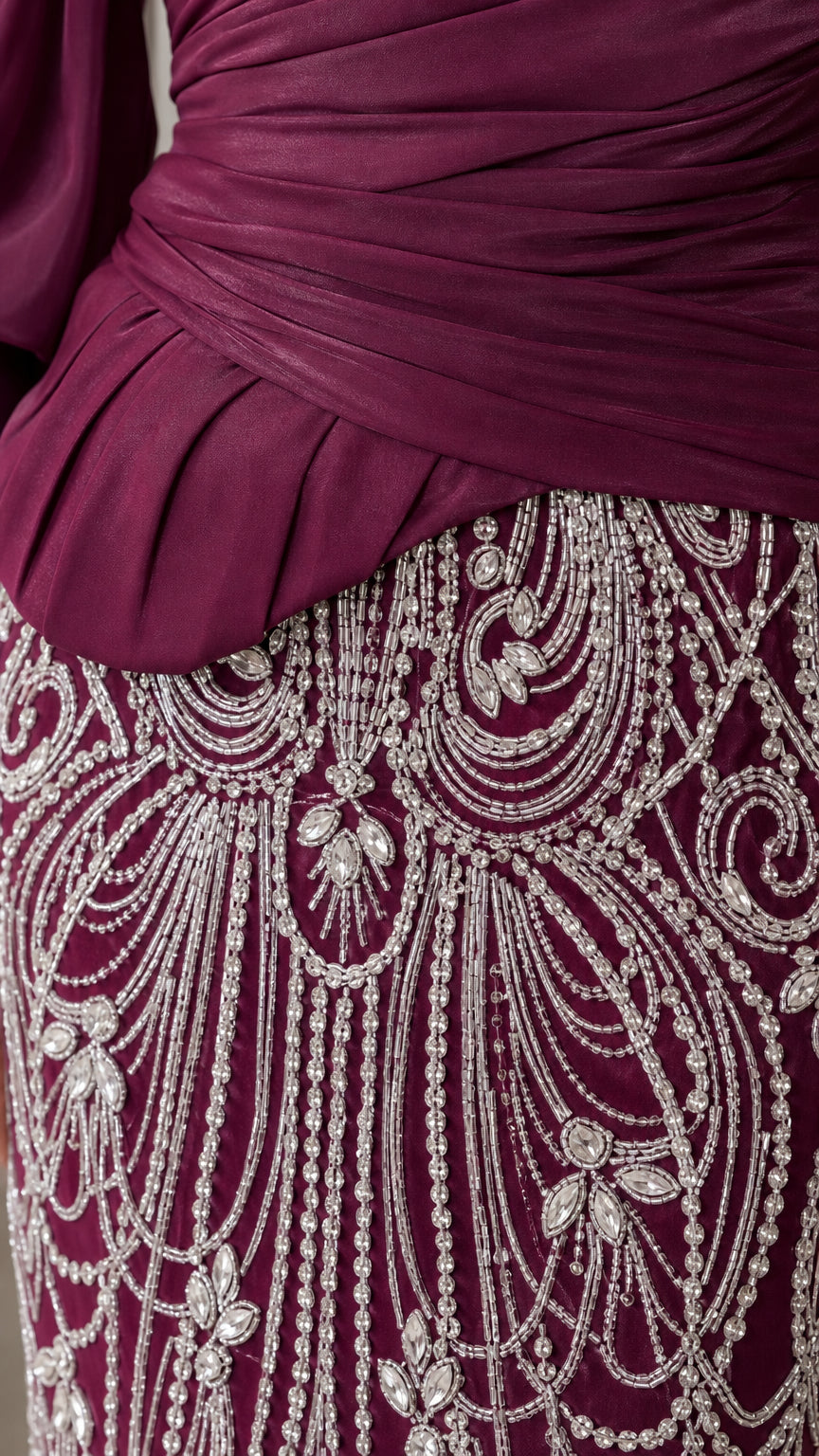 Close-up of beaded crystal pattern and ruched bodice on burgundy dress