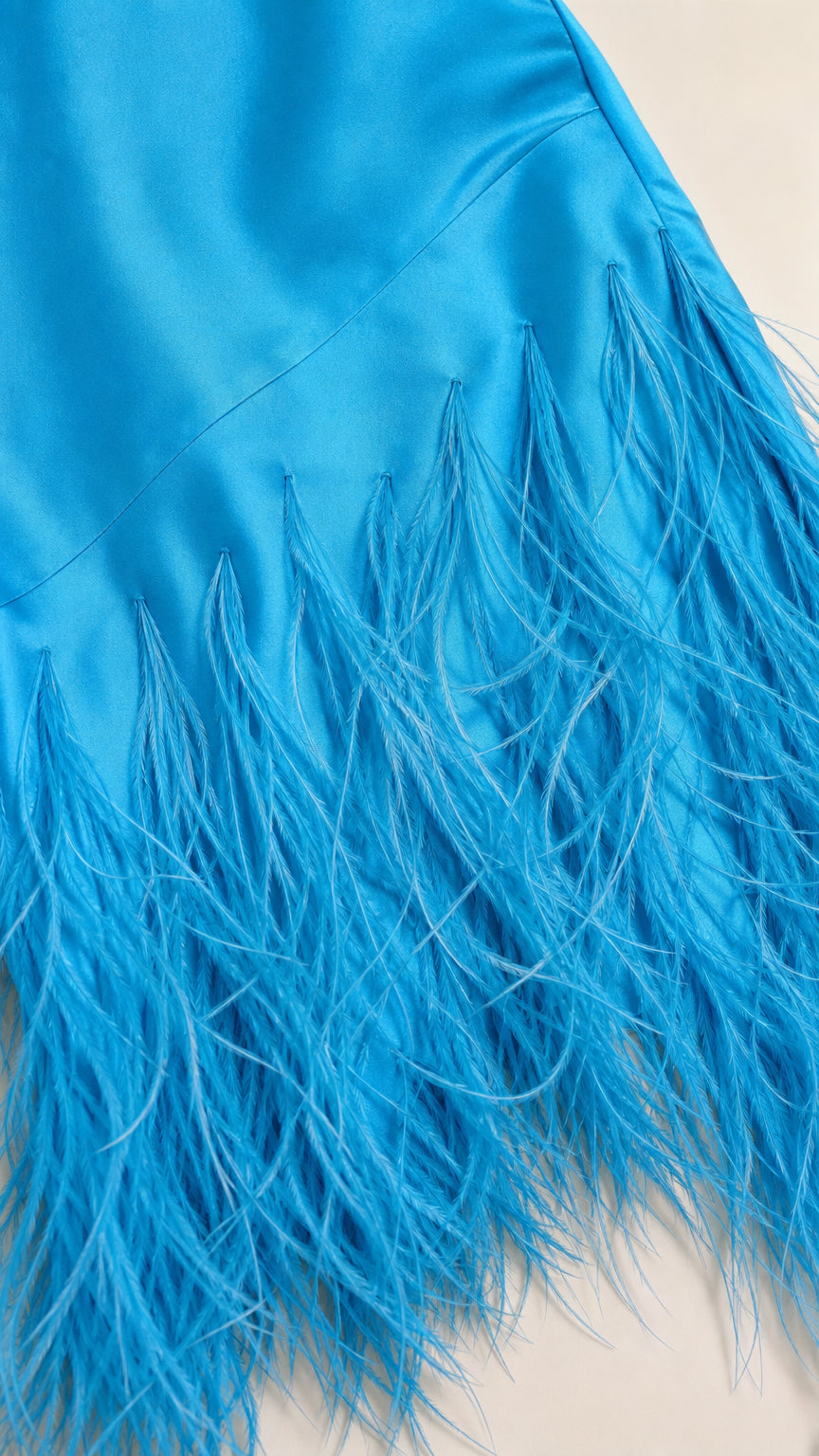 Close-up detail of bright blue feather trim on satin hem