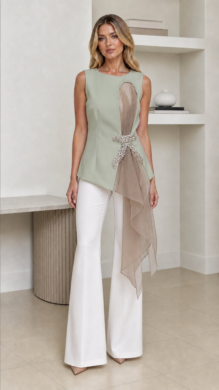 Front view of woman wearing sage green color variant of the asymmetric top