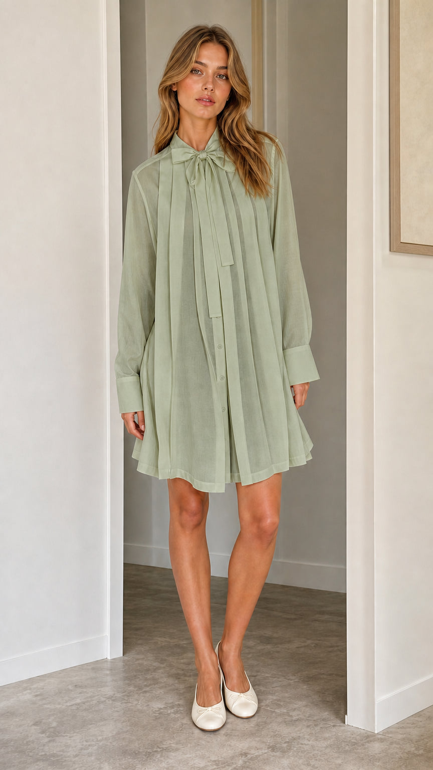 Front full view of sage green pleated shift dress